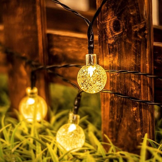 Guirlande guinguette solaire Cristal blanc chaud décorant une barrière